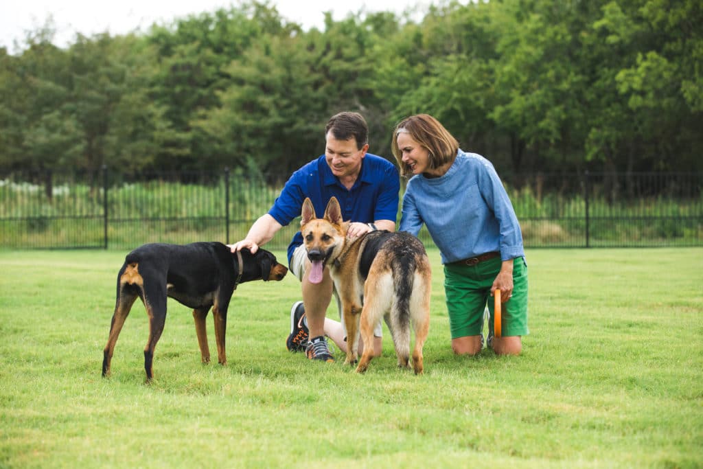 Couple with their Dogs at Sandbrock Ranch's Dog Park